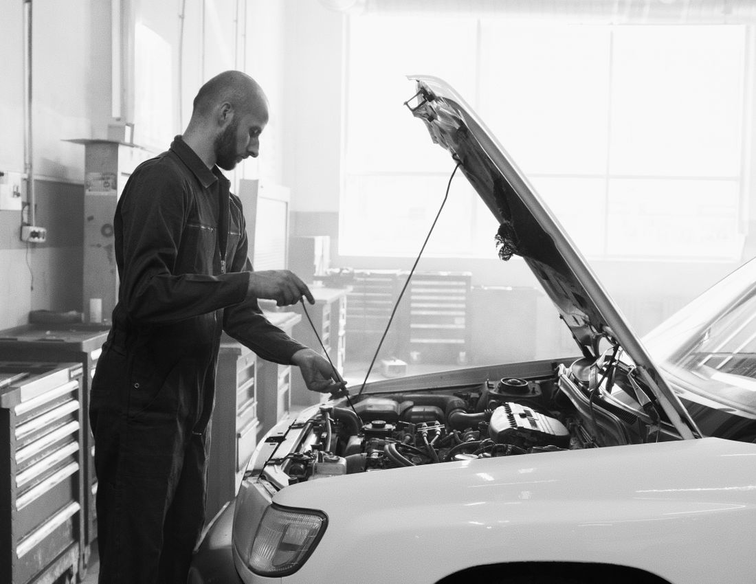 Technician performing scheduled car maintenance