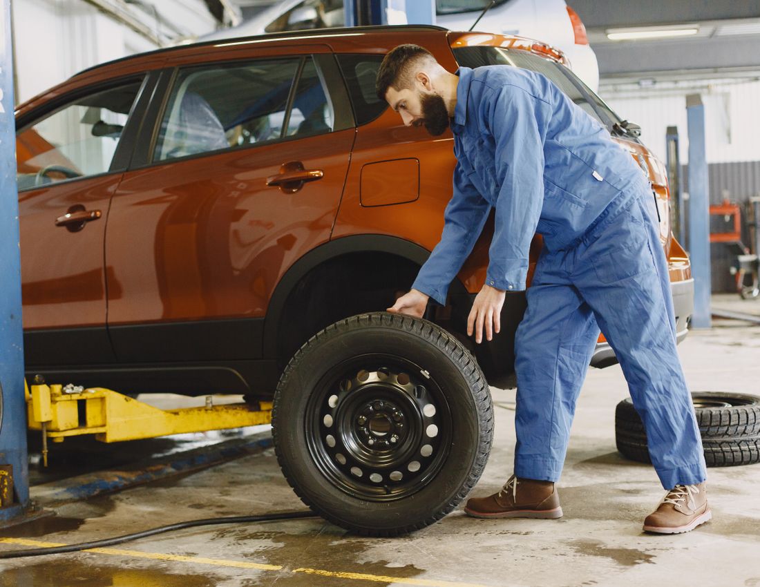 Technician changing car tires